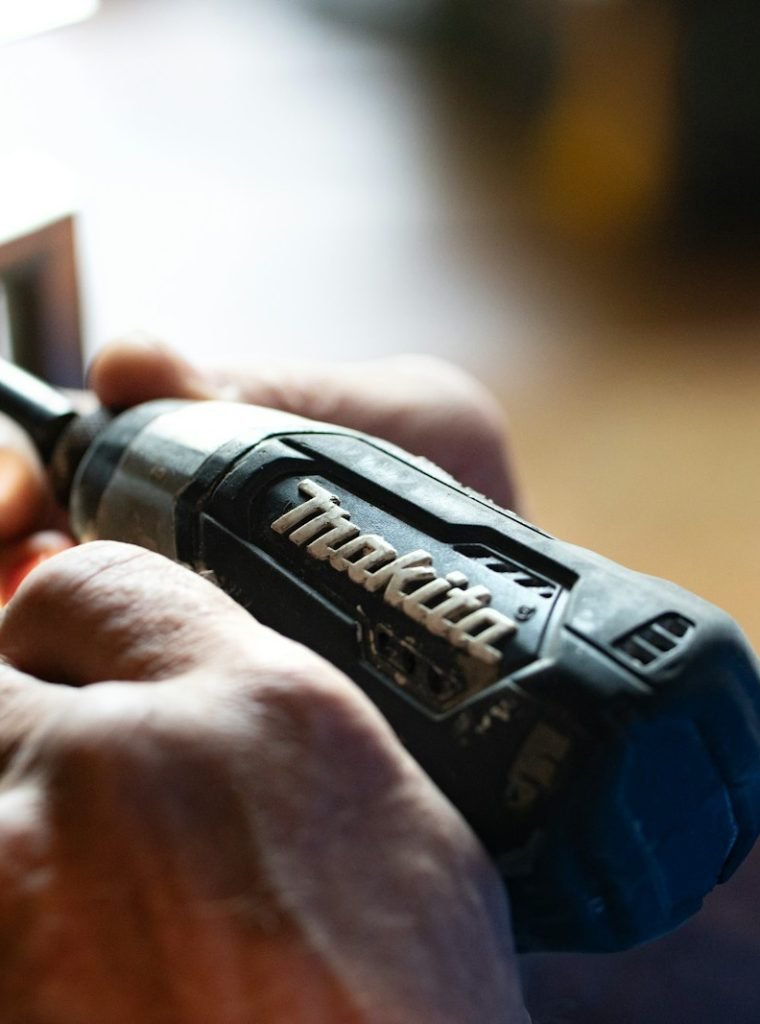 Photo by Theme Photos selective focus photography blue and black Makita power drill